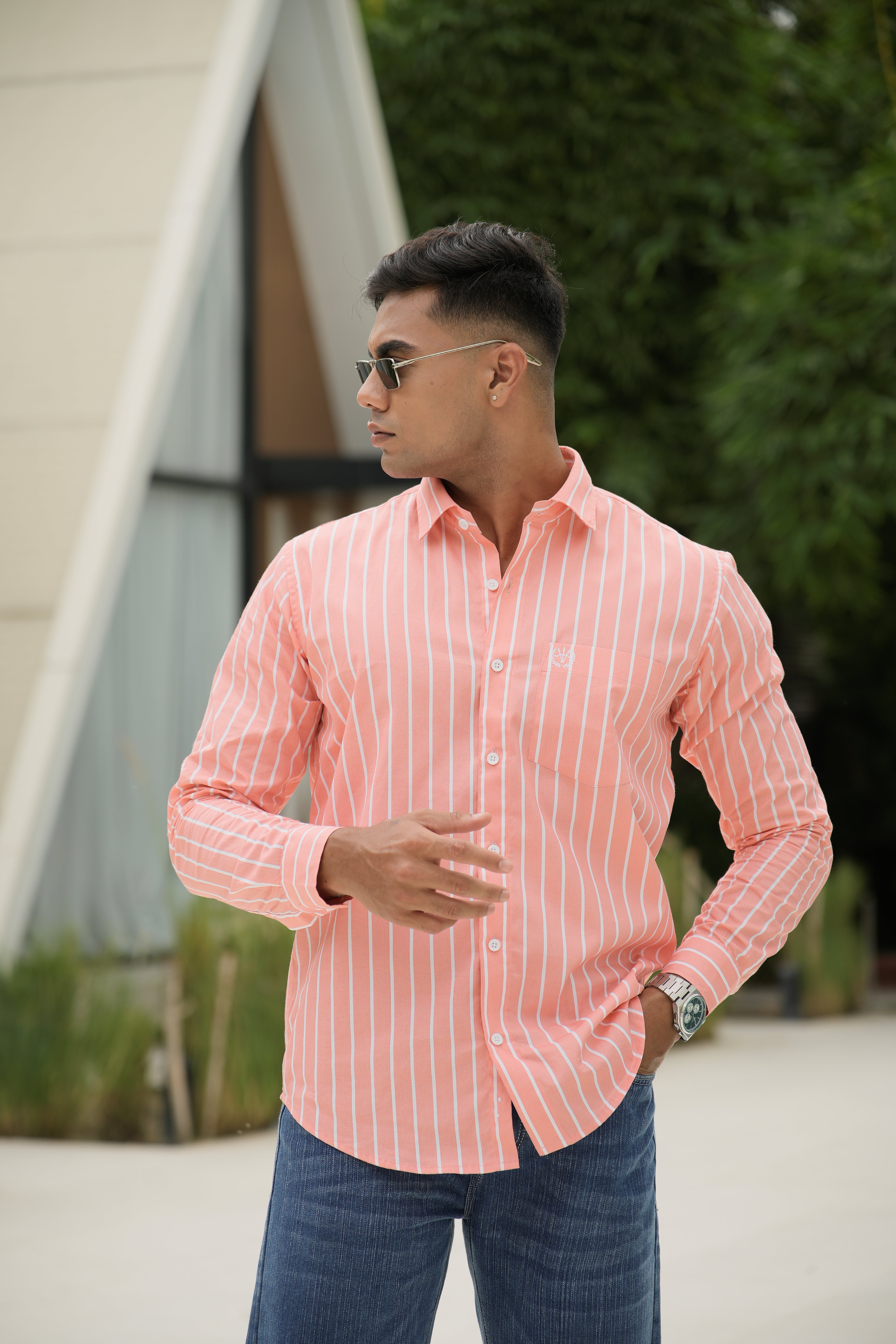 Amerald_arrows Man wearing a pink striped shirt and sunglasses outdoors